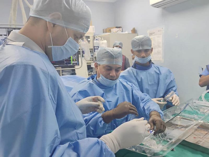 Medical team performing a cardiology procedure in the hospital.