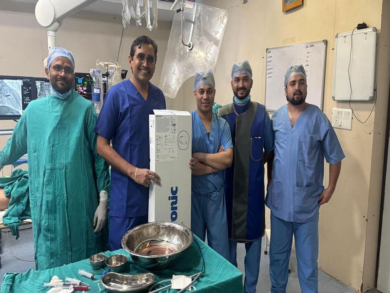 Group of cardiologists and medical staff in operating room.